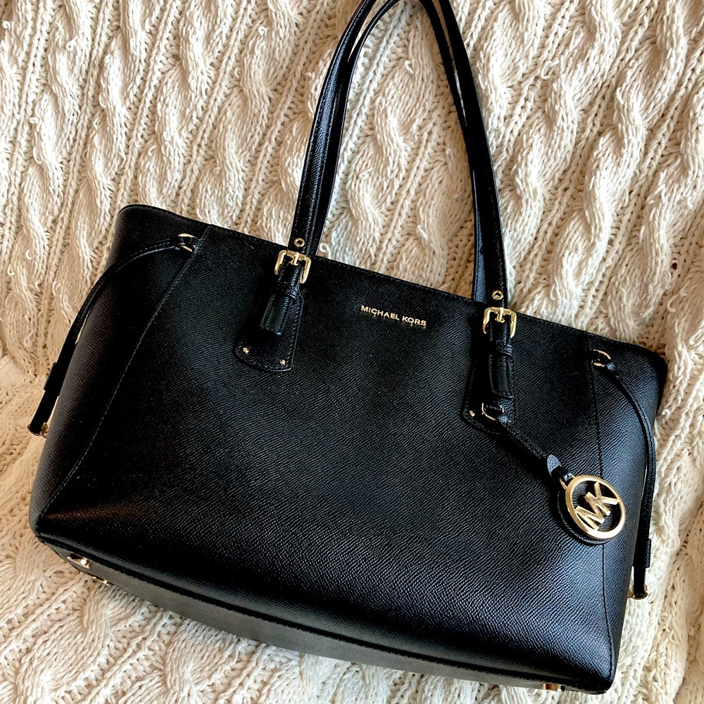 Micheal Kors black pebble leather zip top closure tote.